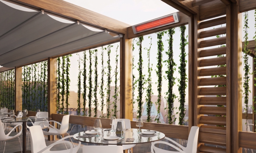 Bromic Cobalt Series electric patio heater mounted above an outdoor dining area